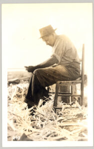 Image showing a man in a chair carving with a knife