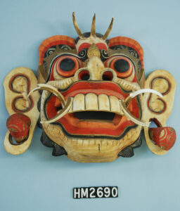 Image of colorful mask with wide eyes and large teeth