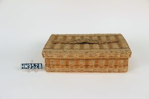 Image of a small rectangular woven basket equipped with a lid fit to close over the top.