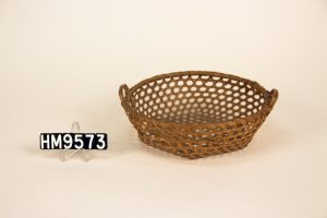 Image of a small basket woven so that the structure of the basket features small hexagonal holes.  