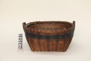 Image of basket with square bottom, round top, a dark blue band, and two small handles.