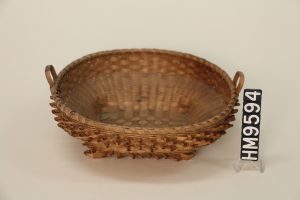 Image of a woven wooden basket with a square bottom and a round top.