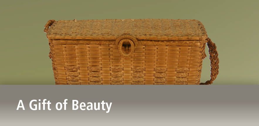 Image of a rectangular purse basket with braided sweetgrass, ring closure, and a braided sweetgrass handle above the title A Gife of Beauty.