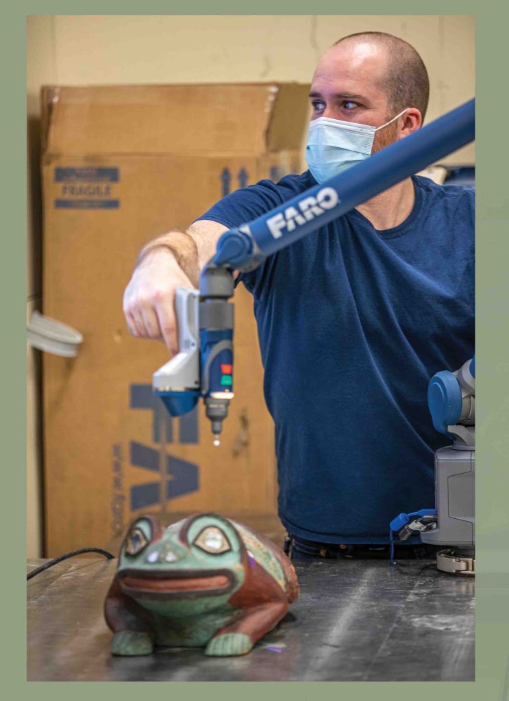 Alexander Cole, Research Engineer; Conducting 3D scans of the original Tlingit helmet for future printing of the replica.