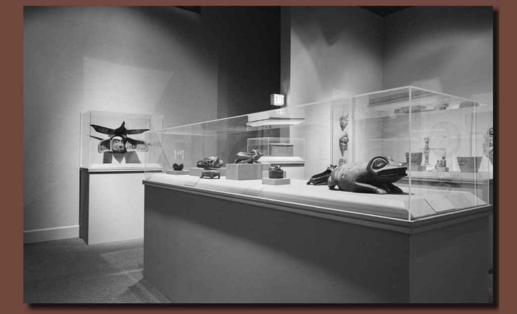 Black and white image of the Symbols of Prestige: Native American Art of Northwest Coast installation. Various 