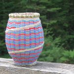 Small barrel-shaped basket with blue, red, and purple.