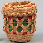 Small fancy basket with red and green details.