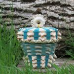 Small fancy basket with teal and an antler handle.