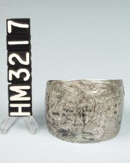 Image of a silver cuff with stylized design of an Eagle from the Great Seal of the United States.