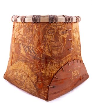 Birchbark container with intricate decorations featuring human faces and a snapping turtle.