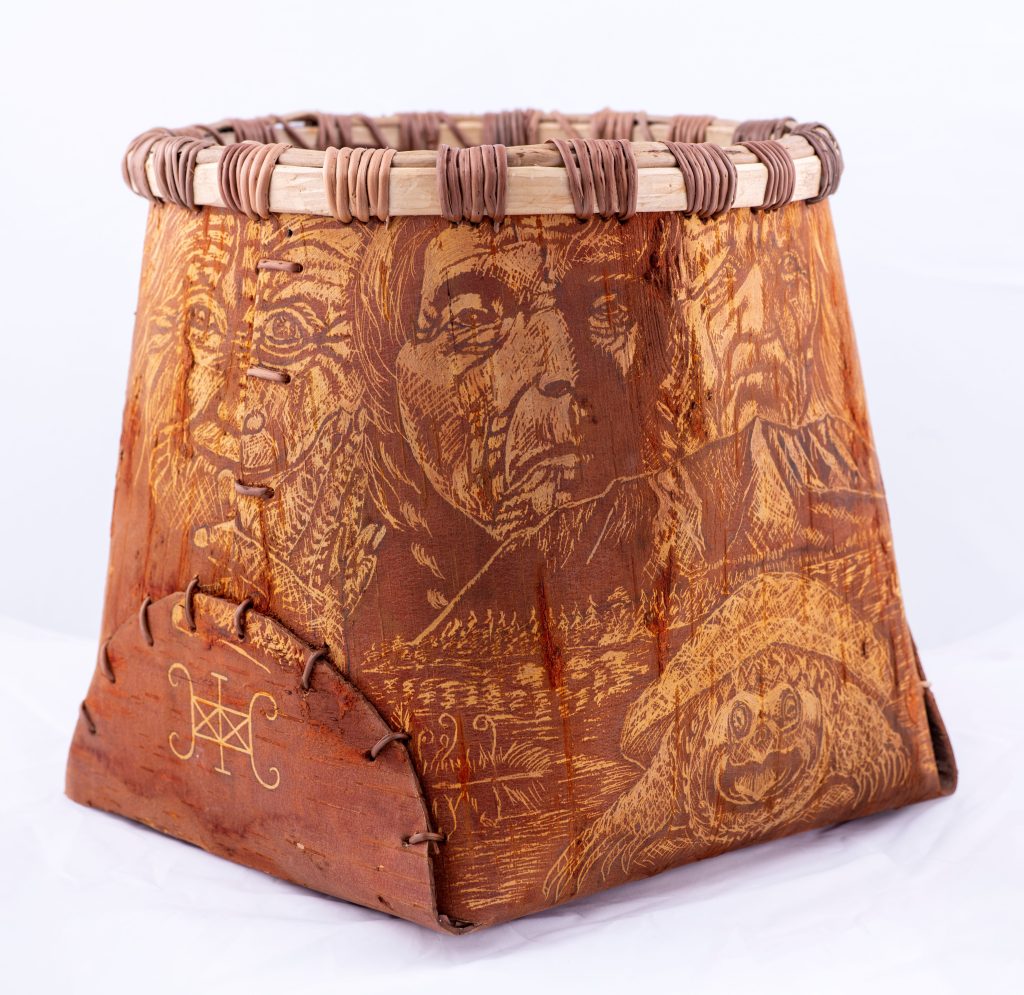 Birchbark container with intricate decorations featuring human faces and a snapping turtle.