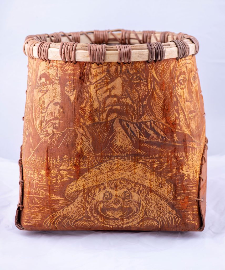 Birchbark container with intricate decorations featuring human faces and a snapping turtle.