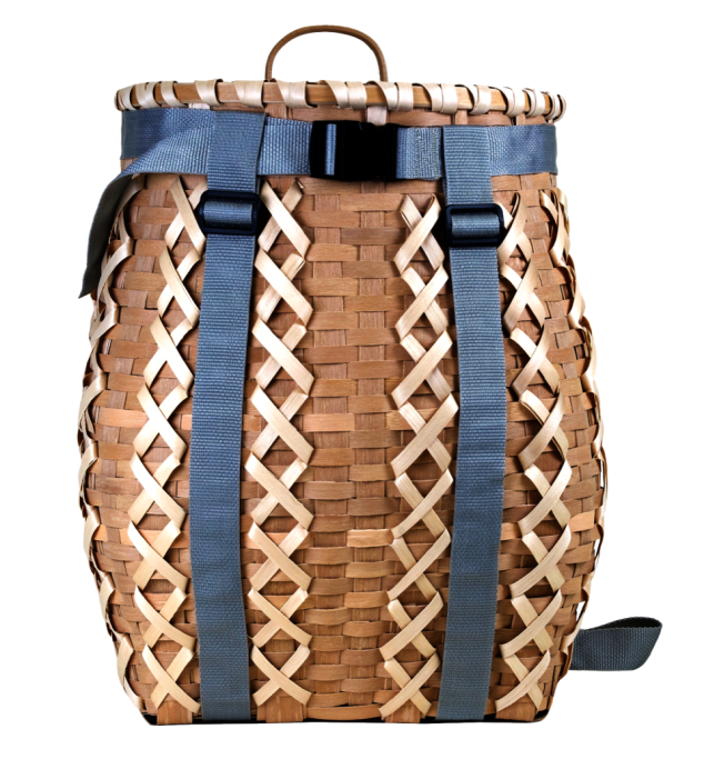 Image of a pack basket with gray straps. The basket had decorative criss-crossed woven elements.