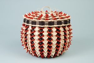 Small tan, black, and red point basket.