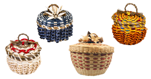 Image of four baskets on a white background. Each is ornately woven with curls and sweetgrass details. Two have sweetgrass braid loop handles and two have brown ash flowers on the cover.