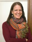 Image of Caucasian woman with dark hair wearing colorful scarf.