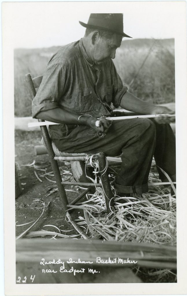 Image showing a man in a chair carving with a knife