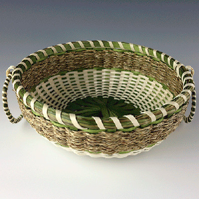 Image of small basket with sweetgrass braids and details.