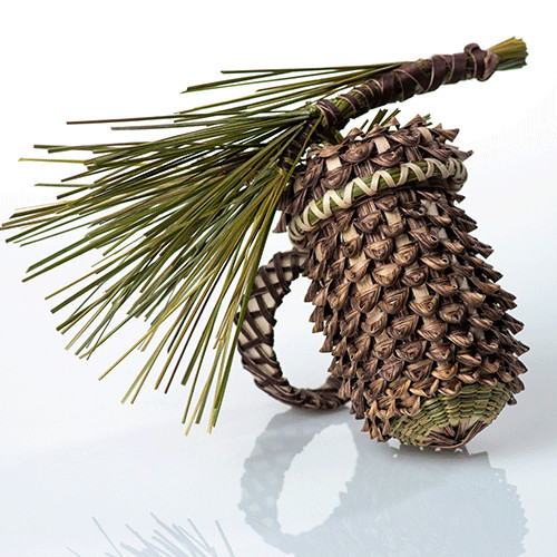 Image of basket shaped like an acorn with pine needle decoration on cover.