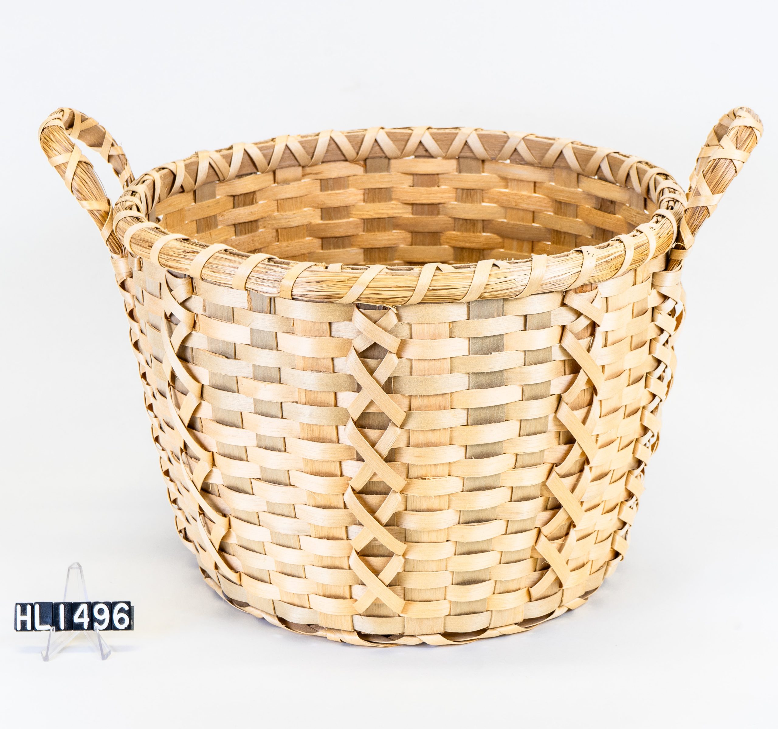 Image of a basket hamper with handles and criss-cross details.