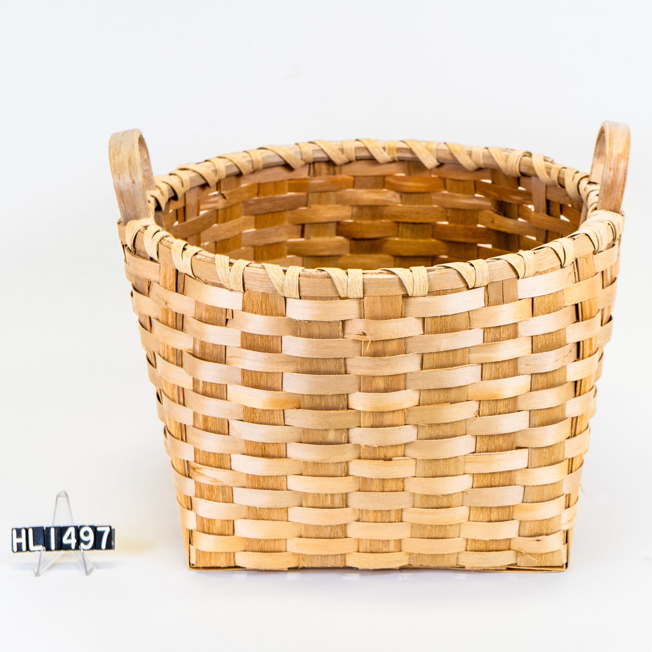 Image of a simple basket with two handles standing from rim.