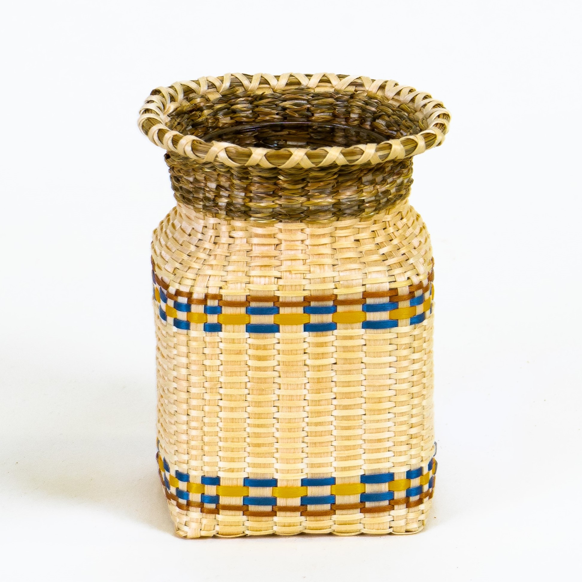 Image of small jar basket with teal and yellow details and sweetgrass.