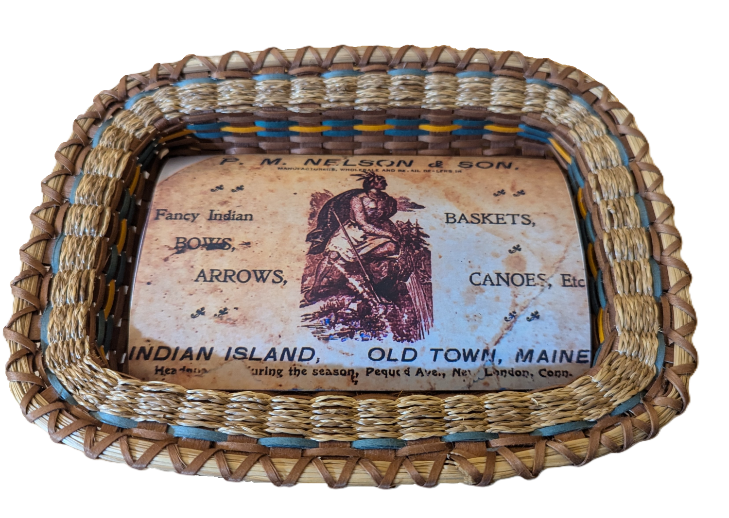 Image of basket woven as a tray holding a print of an antique business card.