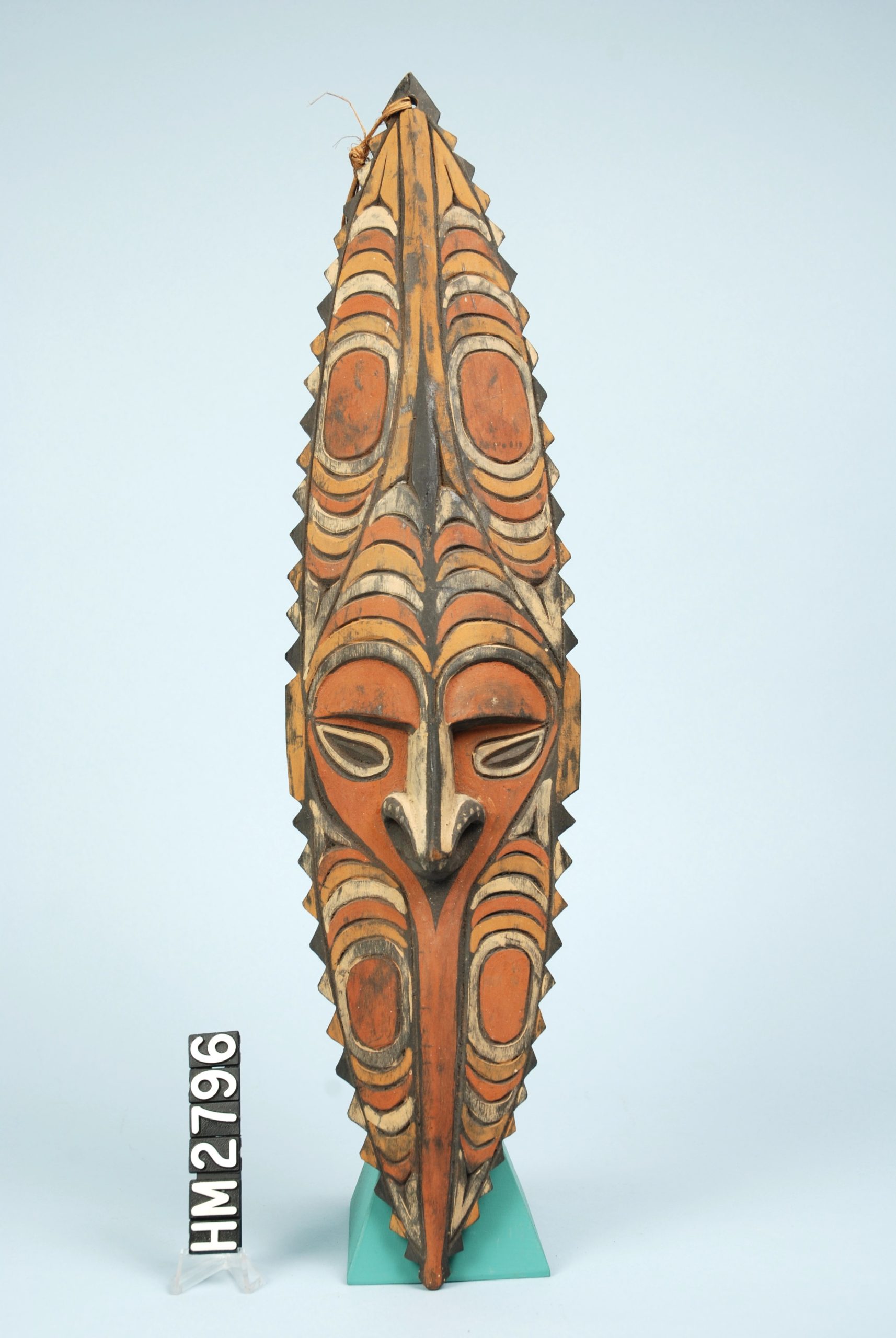 Image of large carved and painted wooden mask - very elongated with exaggerated features.