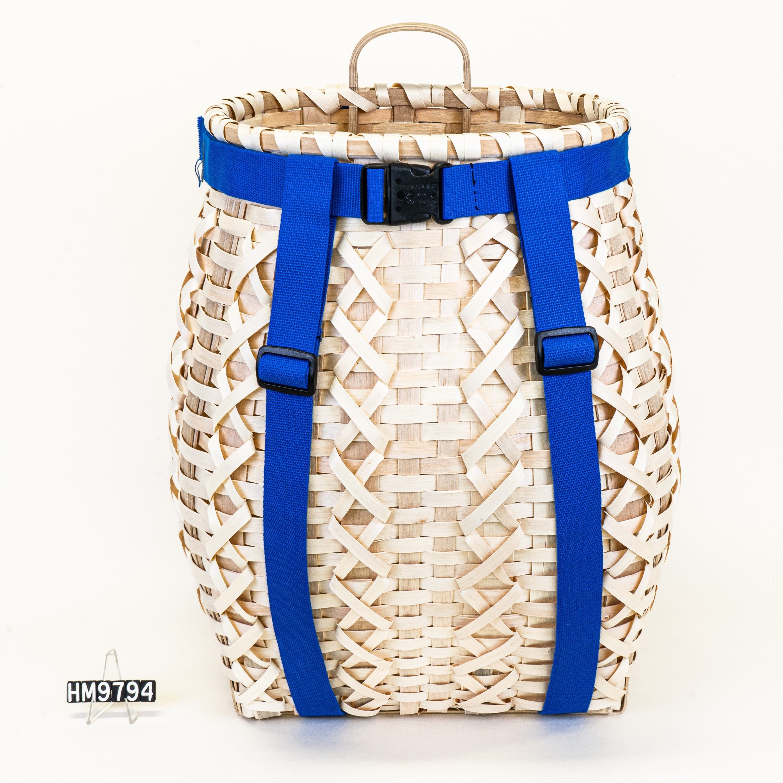Image of a pack basket with criss-cross details and bright blue straps.