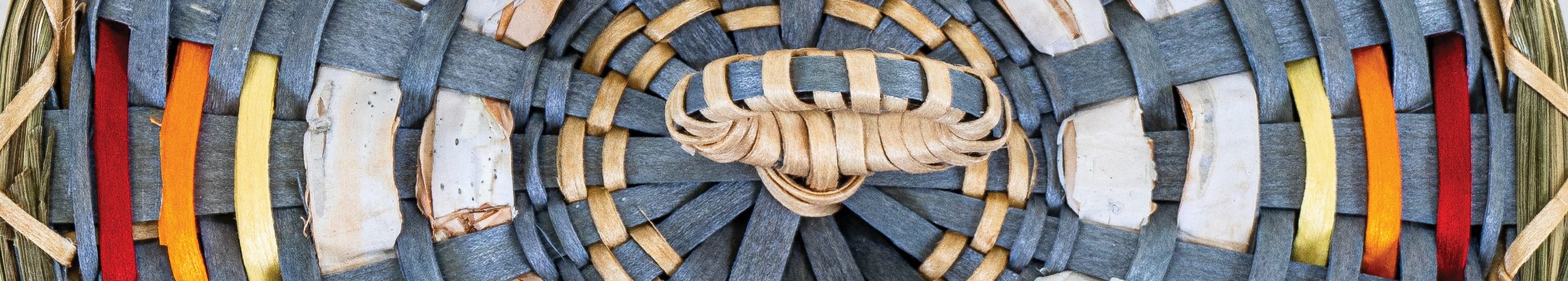 Detail image of a basket cover woven with gray-blue, red, orange and yellow dyed ash and white birchbark.