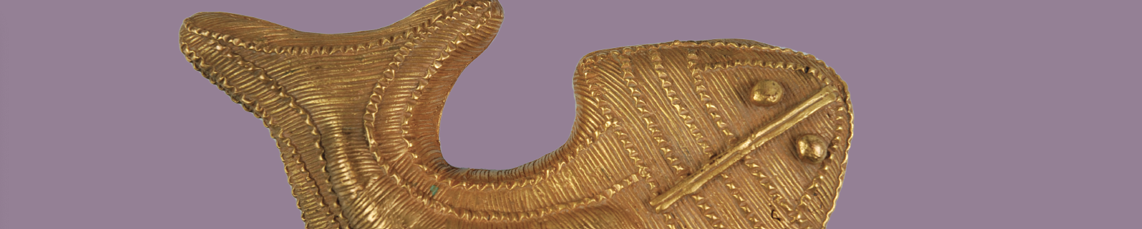 Image of golden fish made of metal on lavender background.