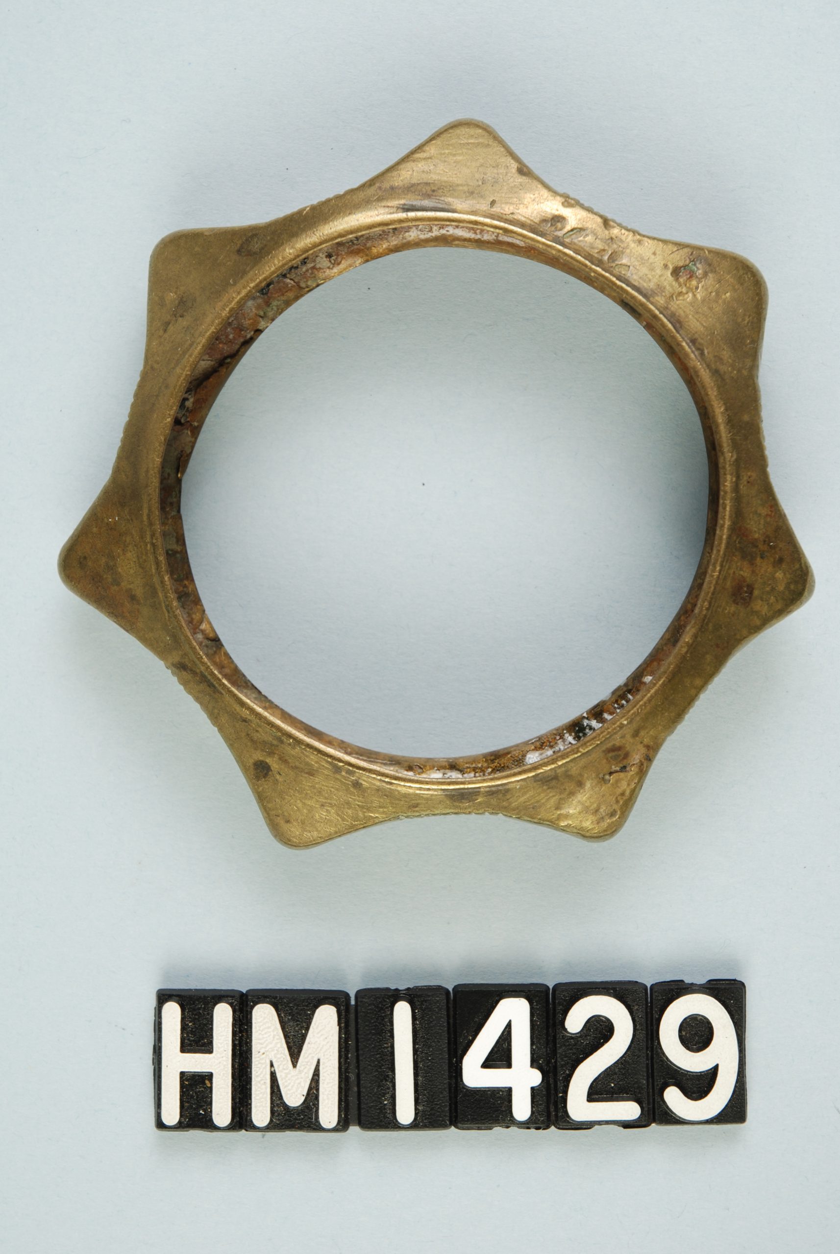 Image of copper bracelet with seven raised points.