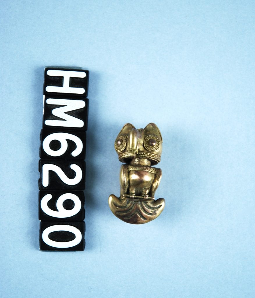 Image of a small golden ornament in the shape of an owl.