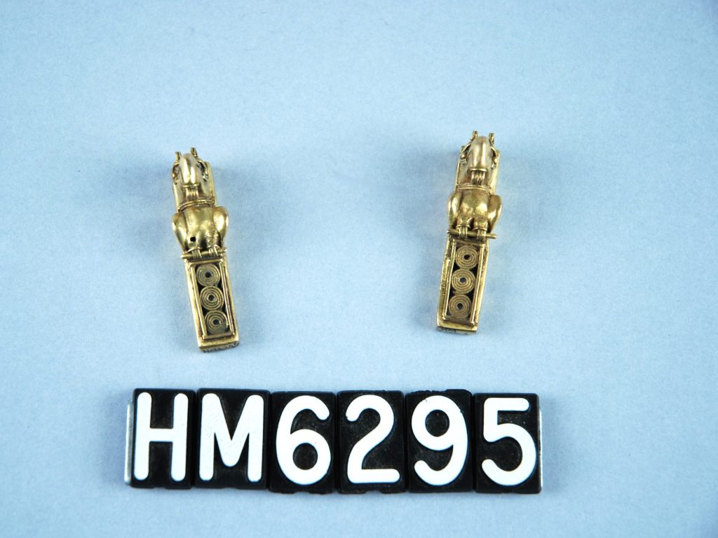 Image of pair of small golden ornaments with birds at top.