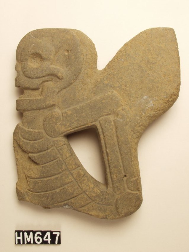 Stone object carved into the shape of a skeletal figure.