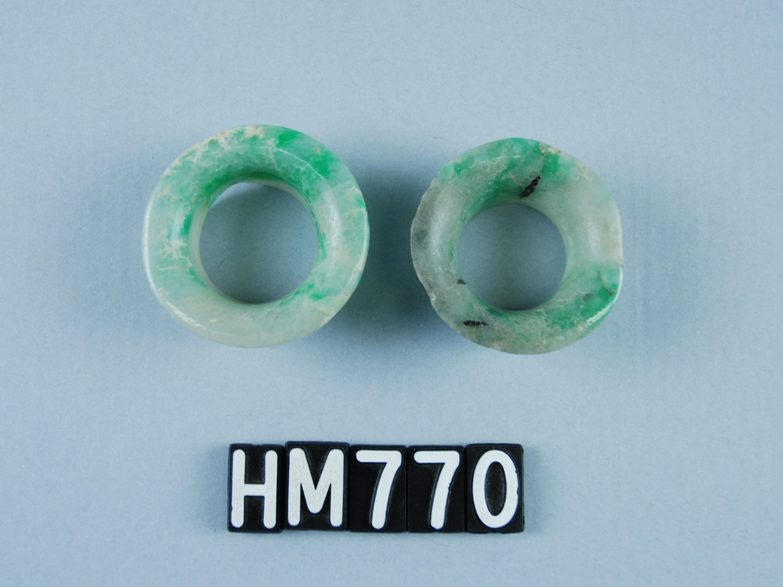 Two ring-shaped ornaments carved of jade.