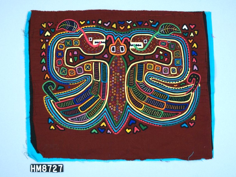 Rectangular fabric with color depiction of a butterfly with each wing made by a snake in an "s" shape with the head at the top, each with a leaf extending from the mouth, and the lower end wider and feathered.