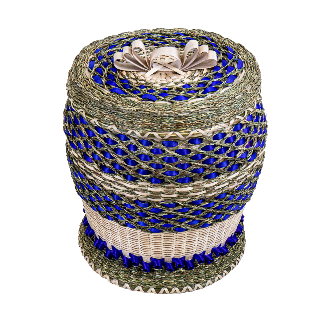 An intricate basket with bright violet and braided sweetgrass details and brown ash bow on cover.