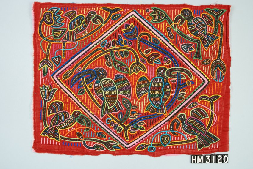 Rectangular fabric object intricately decorated with plant and bird designs within and surrounding a diamond shape.