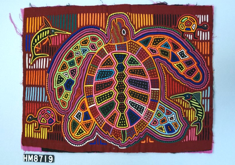 Rectangular fabric depicting a large, beautifully rendered stylized sea turtle, see from above, with animals in each corner,