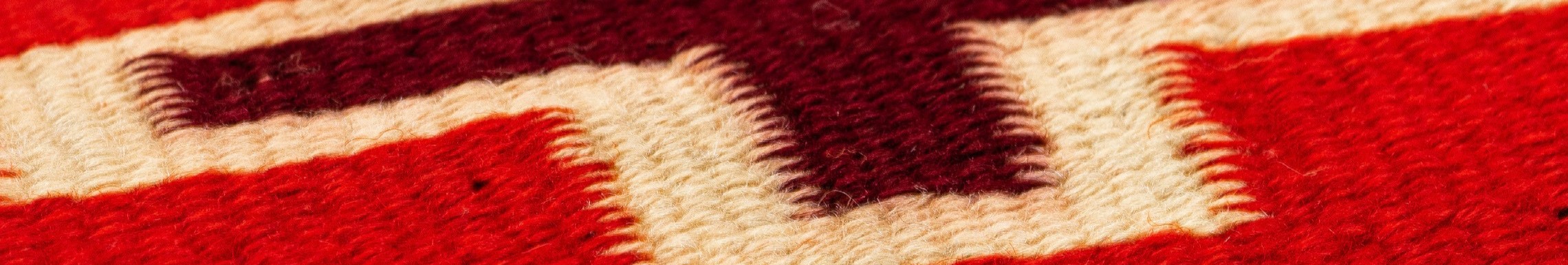 A detailed image of a woven wool textile in red and white.