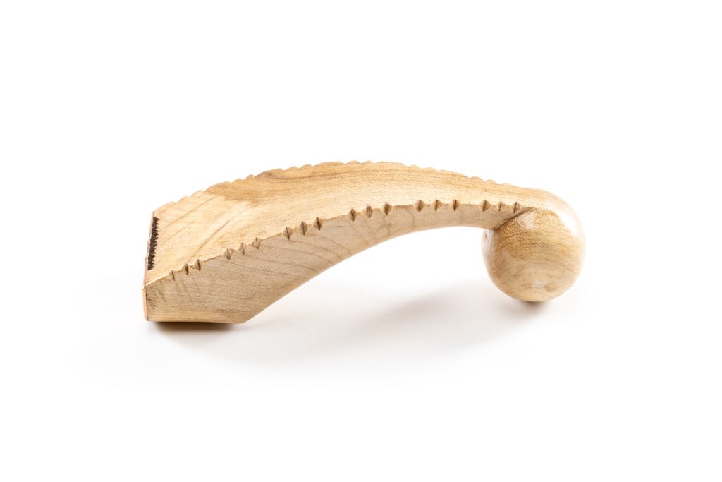 A hand tool with a carved wooden handle.