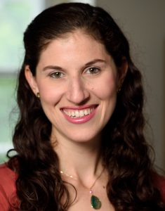Portrait of a Caucasian woman with dark hair smiling at the viewer.
