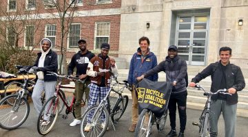 Six people standing with their bicycles