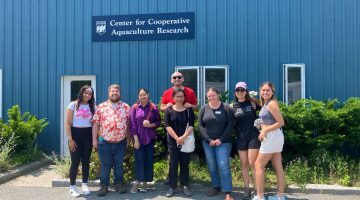 UMaine international student group photo outside of building