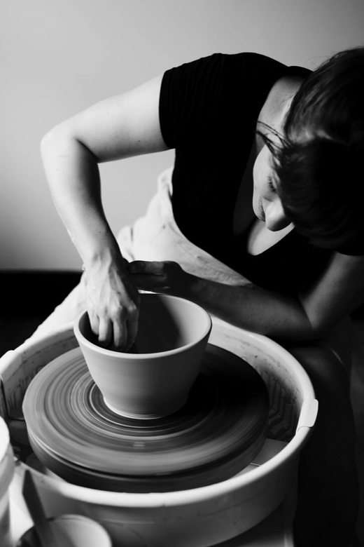 Image of Adriana Cavalcanti throwing a pot on a pottery wheel.