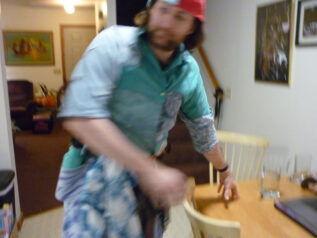 Blurry Image of Walter in a Kitchen, wearing blue, with a red hat