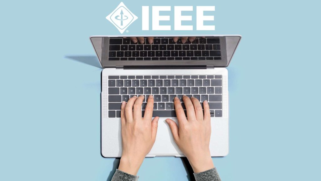 Person typing on laptop with IEEE logo