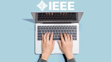 Person typing on laptop with IEEE logo