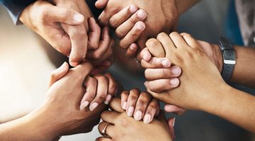 Group of people holding hands